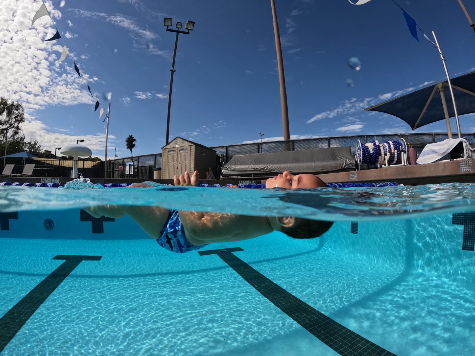 Baby learning to float during swim lesson