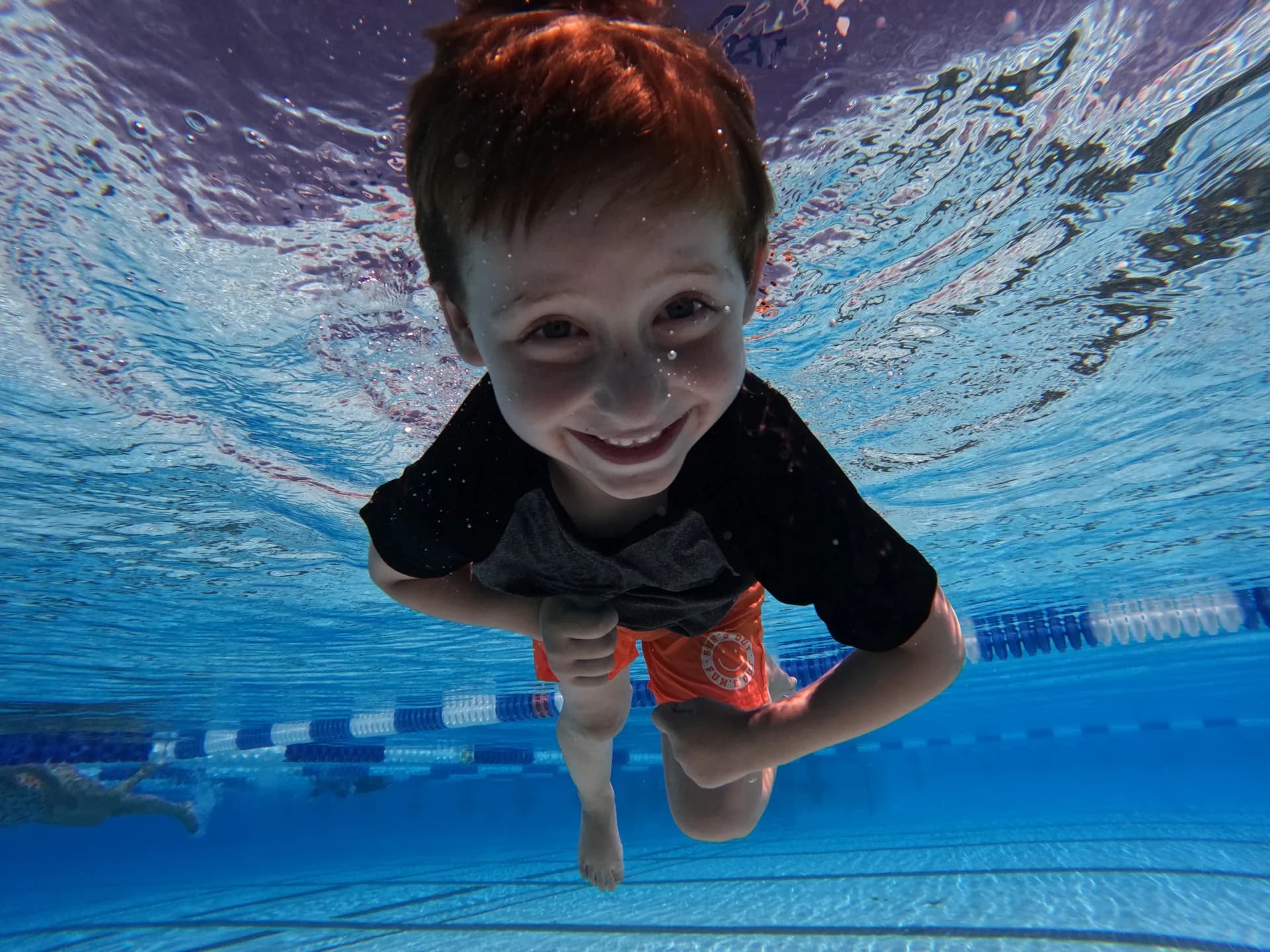 Young boy smiling during swim lesson