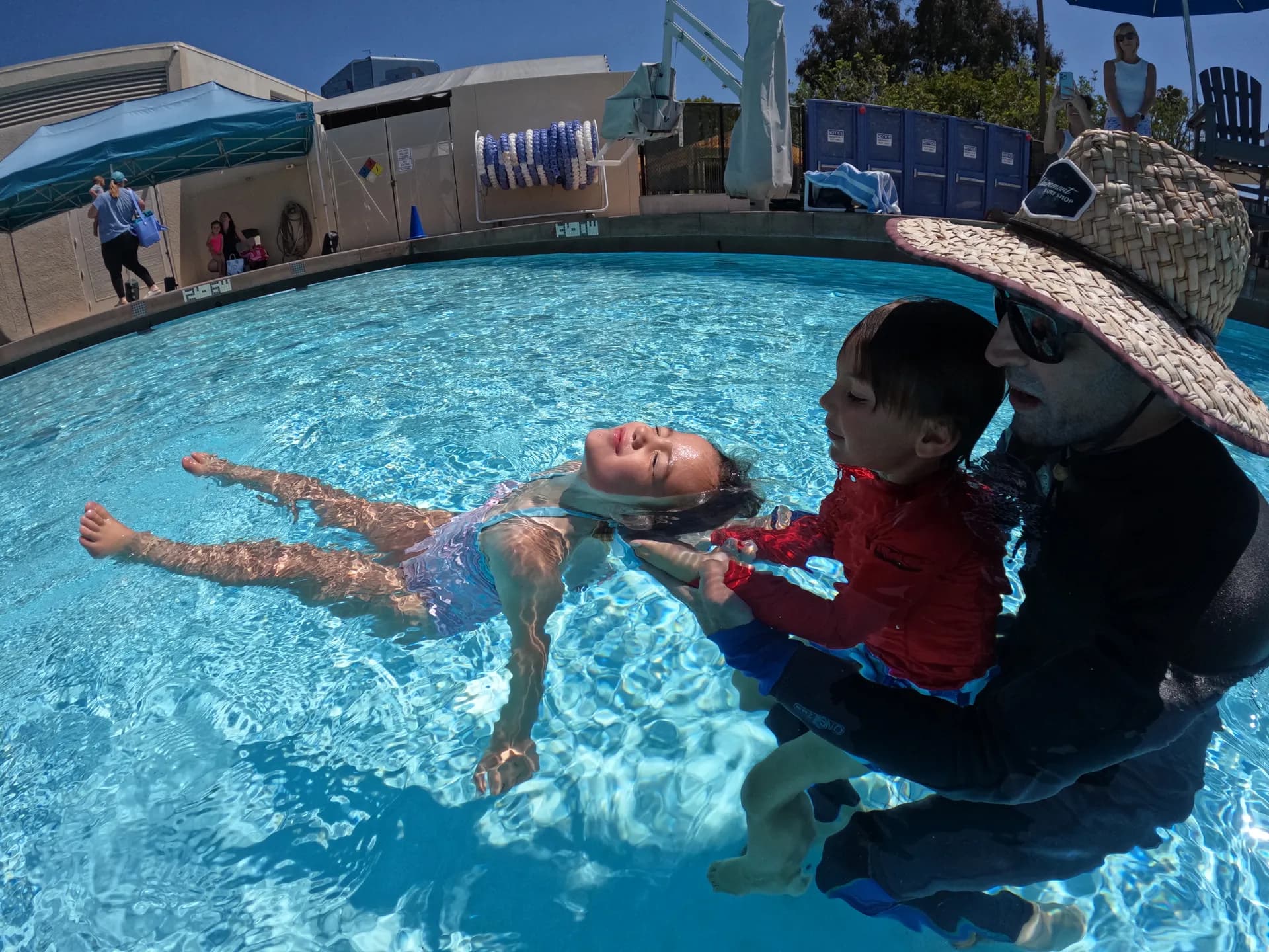 Instructor teaching a child to float safely during ISR swim lesson